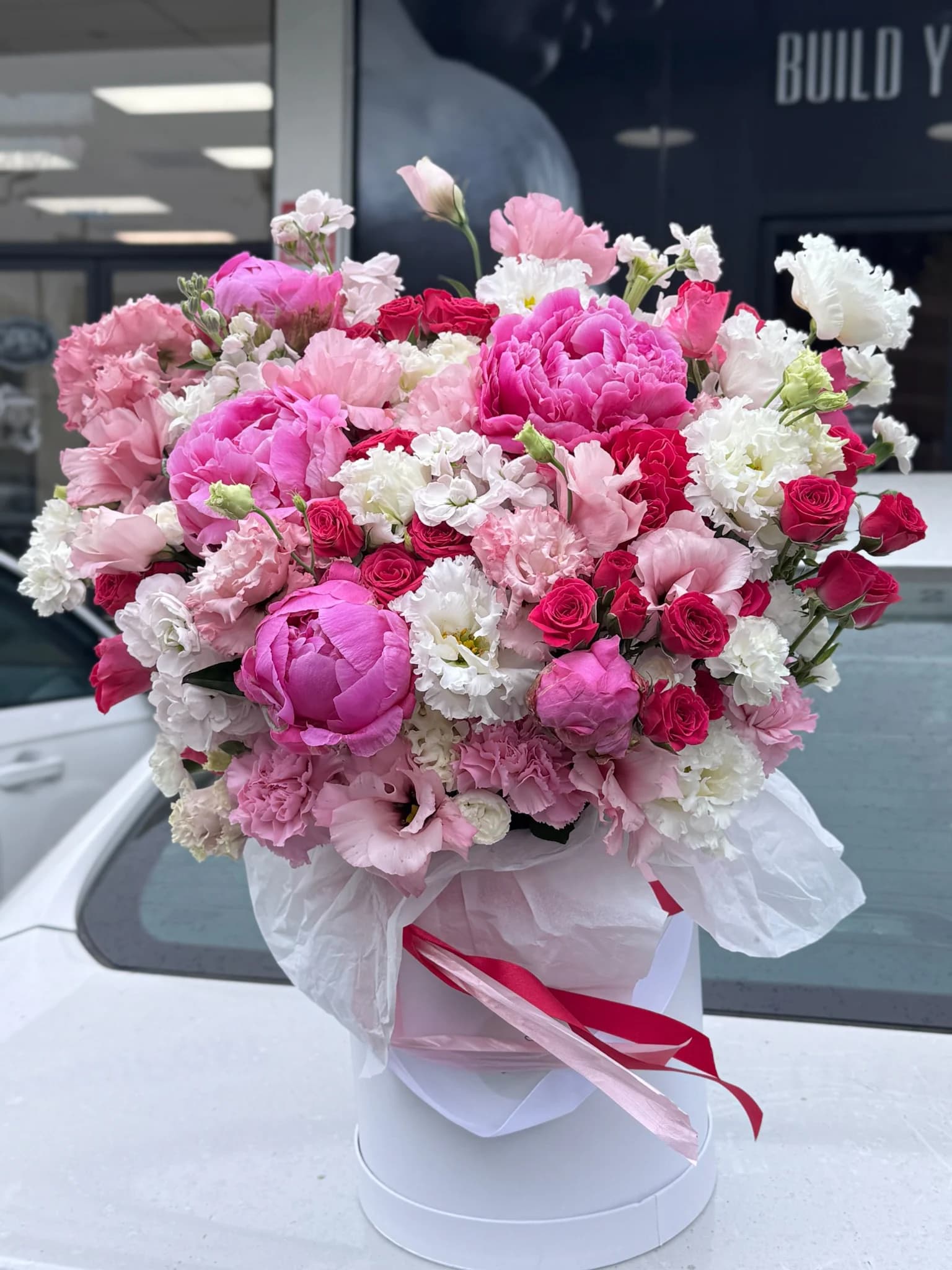 Pink peony, rose, and lisianthus arrangement by Hollywood Blooms